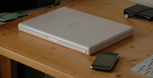 White MacBook with iPhone 3GS